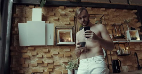 A man enjoy a funny video while drinking his morning tea/coffee. Stock Footage 134680222