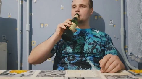 Man enjoying cold bottle of beer after work, delicious drink satisfaction Stock Footage 84039544