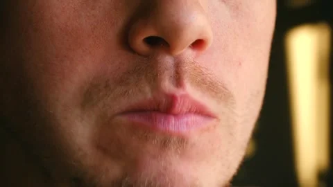 Man enjoying crisp apple in sunlight, Close up of man tasting fresh orchard Stock Footage 337547304