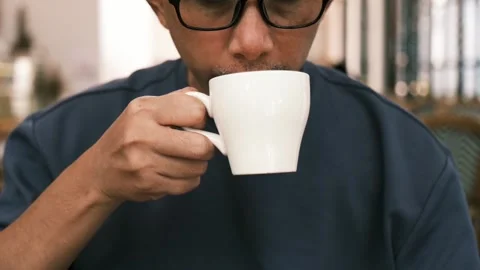Man enjoying drinking coffee at cafetaria Stock Footage 287667408