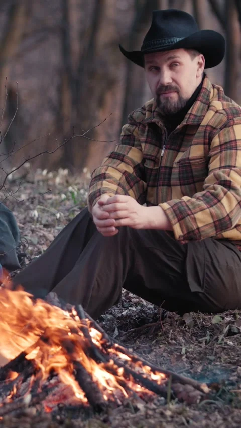 Man Enjoying Fire in Forest Stock Footage 322792622