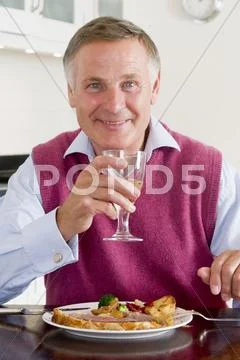 Man enjoying healthy meal,mealtime with a glass of wine Stock Photos