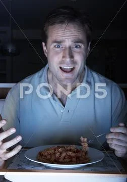 Man Enjoying Meal Whilst Watching TV Stock Photos