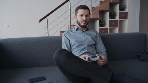 Man is enjoying new digital technology by playing in playstation. Video stock 110805102