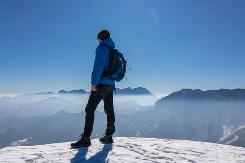 Man enjoying panoramic view from summit Freiberg of Karawanks, Julian Alps,.. Stock Photos
