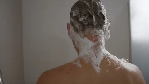 Man enjoying a refreshing shower while washing his hair Stock Footage 300649110