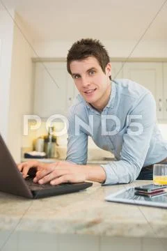 Man enjoying typing at the laptop Stock Photos