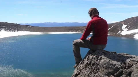 Man enjoying the view over blue lake in Tongariro Stock Footage 50482569