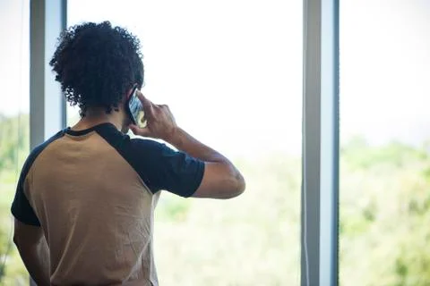 Man enjoying view while taking phone call Stock Photos