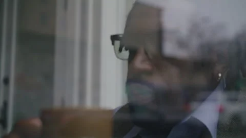 Man enjoys coffee while working on laptop at cozy coffee shop Stock Footage 312473315