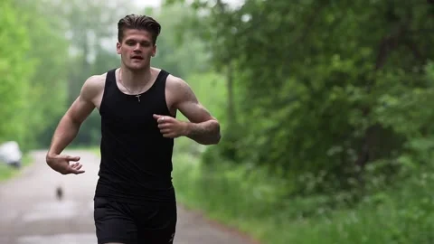 A man enjoys running at a park Stock Footage 132054863