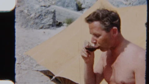 Man Enjoys Sumptuous Meal Beside Tent At Beach Campsite Stock Footage 322133911