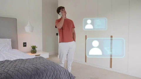 Man entering bedroom, calling while checking phone contacts, causing tech panels Stock Footage 333602288