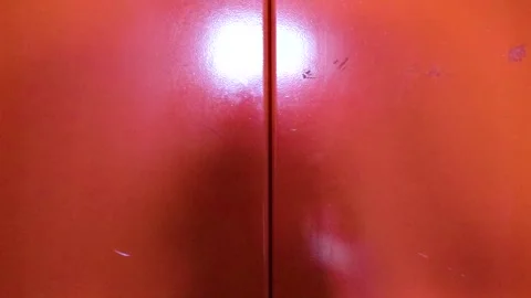 Man Entering Bright Orange Elevator Inside Modern Building During Business .. 库存影片 340543045