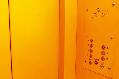 Man Entering Bright Orange Elevator Inside Modern Building During Business .. Stock Photos
