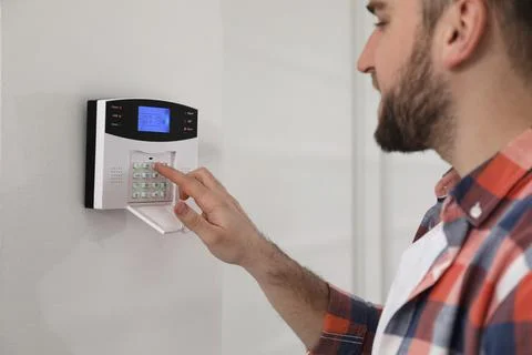 Man entering code on home security system, closeup Stock Photos