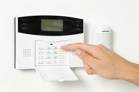 Man entering code on home security system indoors, closeup 스톡 사진