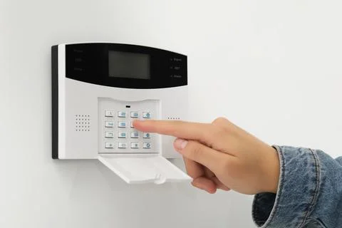 Man entering code on home security system indoors, closeup Stock Photos