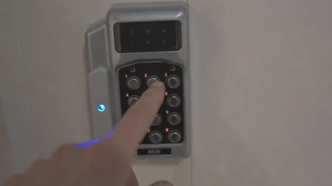 Man entering code on keypad at door entry lock Stock Footage 153271050