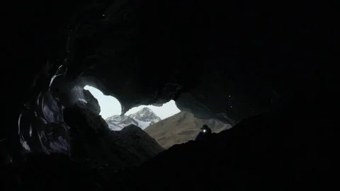 Man Entering A Dark Cave Stock Footage 76036214