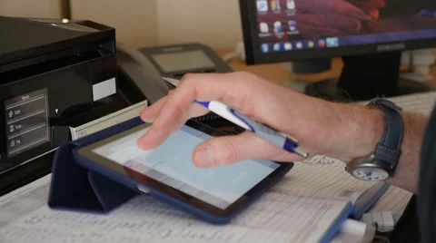 Man entering data on a iPad. Stock Footage 49911705