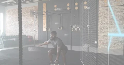 Man entering gym and gripping kettlebell, performing windmill bend with pulsing Stock Footage 318179953