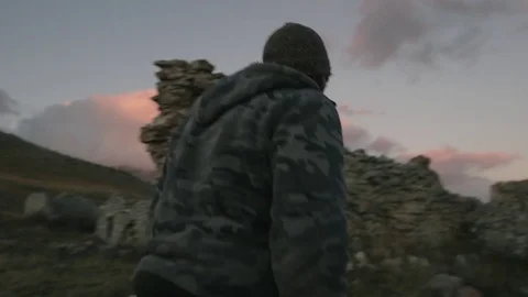 Man Entering Mountain Stone Hut Stockbeeldmateriaal 75207161