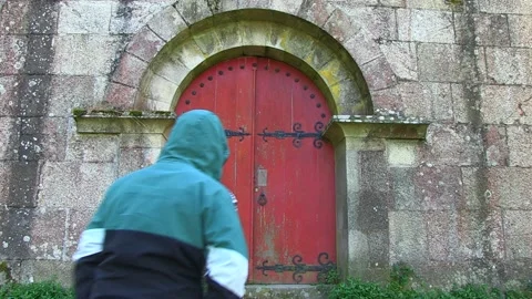MAN ENTERING AN OLD RED DOOR Stock Footage 96286494