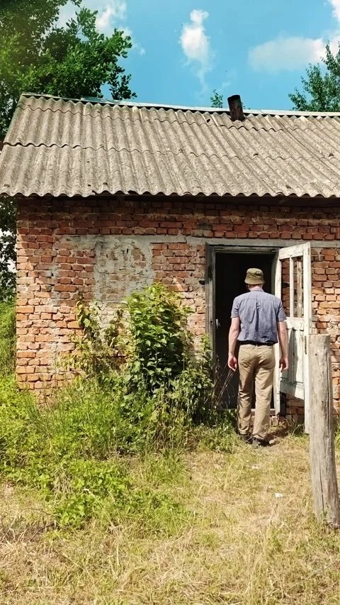 Man Entering Old Rustic Brick Countryside House Stock Footage 339620260