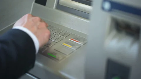 Man entering pin code, making mistake and pressing correction button on ATM Stock Footage 90897315