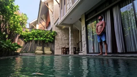 Man entering private swimming pool at luxury villa Stock Footage 340848016