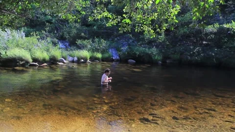 A man entering a river for a cold bath in the Brazilian countryside close to Bel Stock Footage 194396142