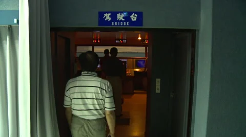 A man entering the room of a maneuvers simulator. Port of Kaohsiung, Taiwan. Stock Footage 66445558