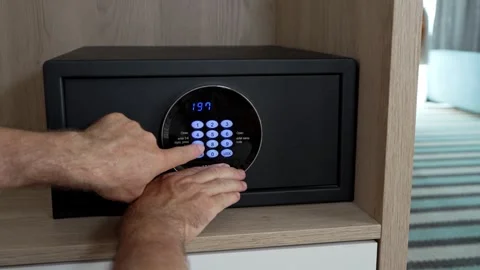 Man entering security code on hotel safe keypad. Travel safety Stock Footage 341872615