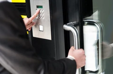 Man entering security code to unlock the door Stock Photos