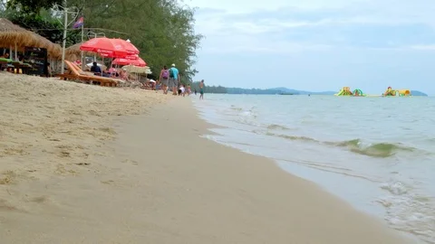 A man entering the water at the beach Stock Footage