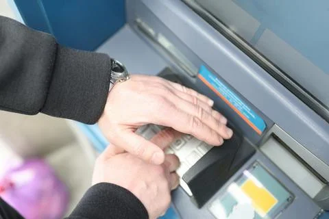 Man enters code on ATM keyboard and closes it with his hand Stock Photos