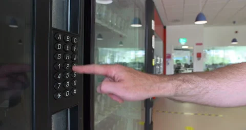 Man enters code on snack food drink machine keypad work office canteen Stock Footage 156680649
