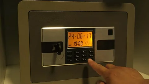 A man enters the correct code into the keypad of a safe 스톡 동영상 277592771