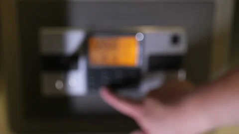 A man enters the correct code into the keypad of a safe 스톡 동영상 277592958