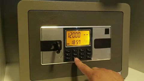 A man enters the correct code into the keypad of a safe 스톡 동영상 277593051