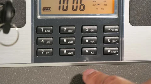 A man enters the correct code into the keypad of a safe, unlocking its door Vidéo 277934379