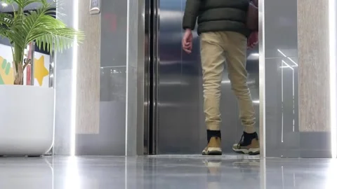A man enters the elevator and the doors close Stock Footage 255901995