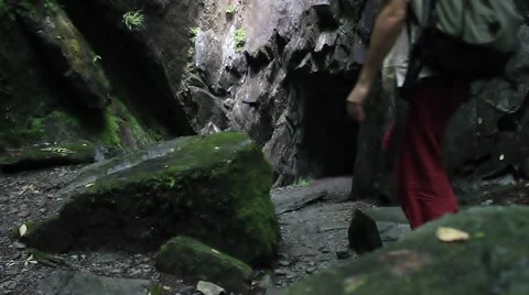 Man enters mountain cave Stock Footage 41936645