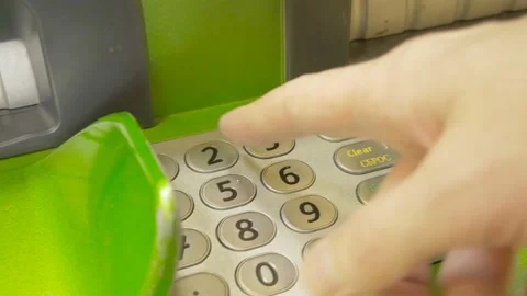 A man enters a PIN code in an ATM Stock Footage 87003626