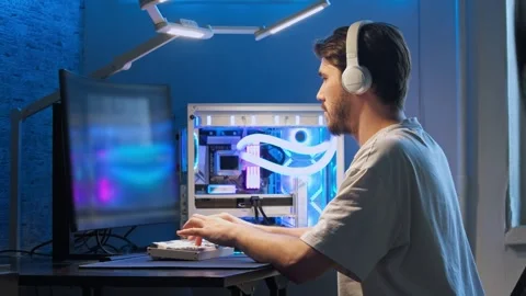 Man is enthusiastically working on his powerful, expensive gaming computer with Stock Footage 279019904