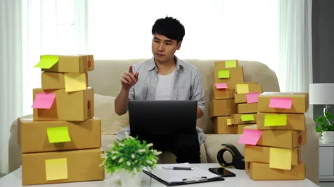 Man entrepreneur working with laptop computer and checking to prepare parcel box 스톡 동영상 143768007