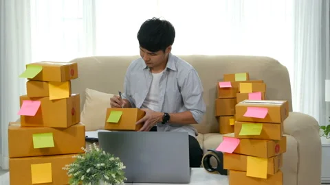 Man entrepreneur working with laptop computer prepare parcel boxes Stock Footage 144613095