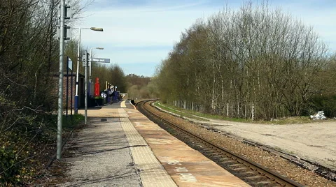 Man at Entwistle request stop train station on Blackburn to Bolton railway Stock Footage 62996405