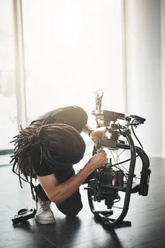 Man, equipment and camera operator in film or media production for shoot, script Stock Photos